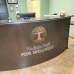 A reception desk with the logo for holistic health for wellness.